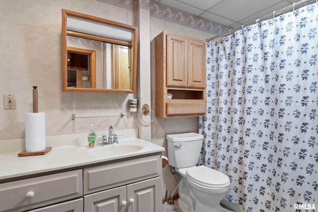 bathroom featuring a shower with curtain, a paneled ceiling, vanity, and toilet