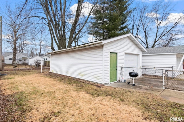 view of outbuilding with a yard and a garage