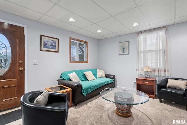 carpeted living room featuring a paneled ceiling