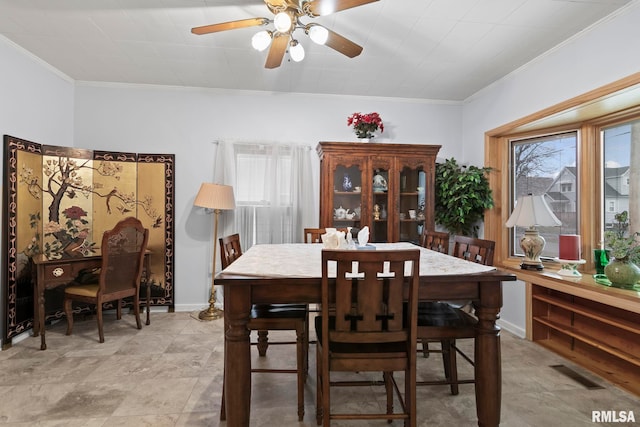 dining room with ornamental molding and ceiling fan