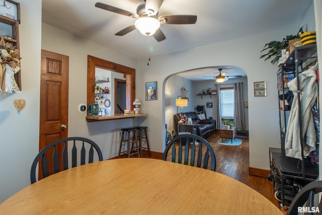 dining space featuring dark hardwood / wood-style flooring and ceiling fan