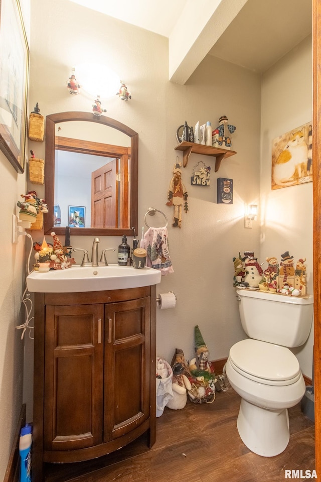 bathroom featuring hardwood / wood-style flooring, vanity, and toilet