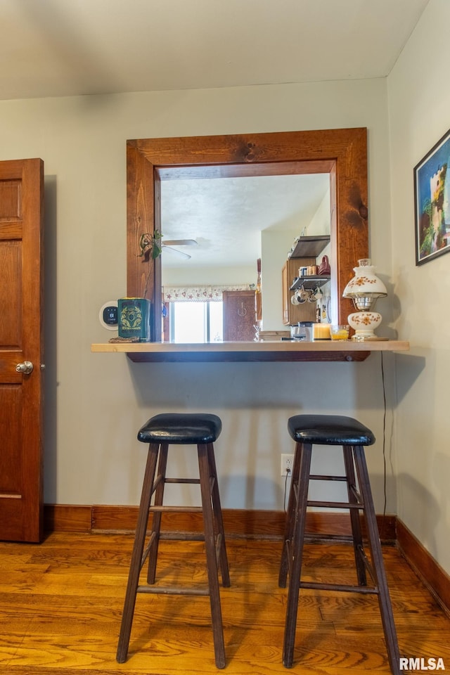 interior space with hardwood / wood-style flooring and a breakfast bar