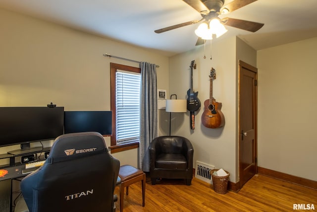 office with wood-type flooring and ceiling fan