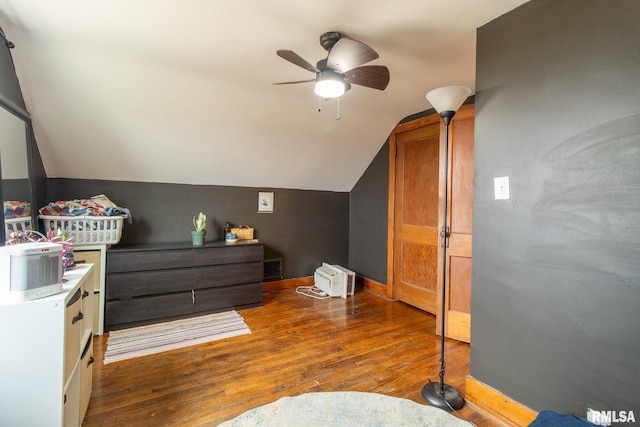 bedroom featuring hardwood / wood-style flooring, ceiling fan, and lofted ceiling