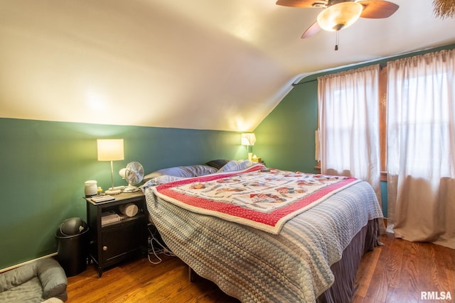 bedroom featuring ceiling fan, lofted ceiling, and hardwood / wood-style floors