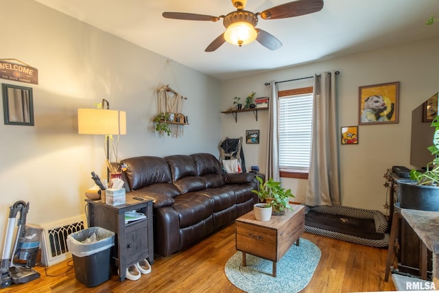 living room with hardwood / wood-style flooring and ceiling fan