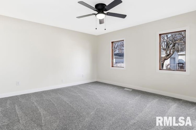 carpeted spare room with ceiling fan and a healthy amount of sunlight