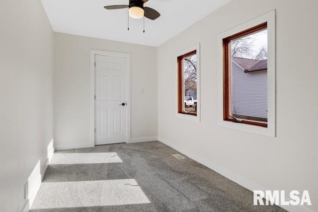 unfurnished room with carpet floors and ceiling fan