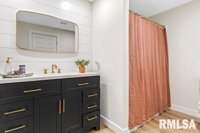 bathroom featuring hardwood / wood-style flooring, vanity, and toilet