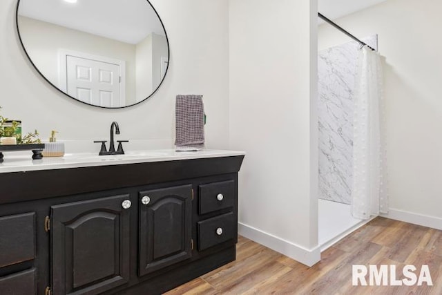 bathroom with vanity, hardwood / wood-style floors, and curtained shower