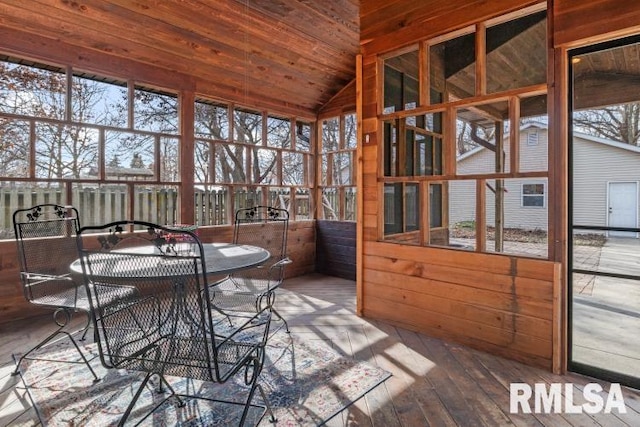 unfurnished sunroom featuring lofted ceiling and wooden ceiling