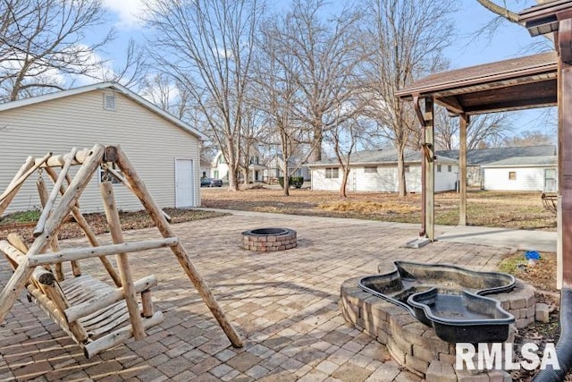 view of patio / terrace featuring an outdoor fire pit