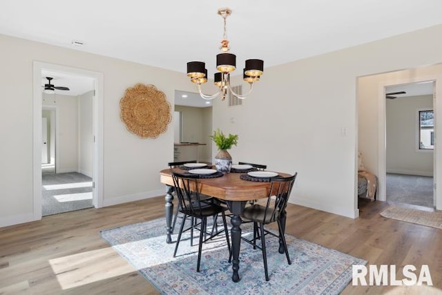 dining room featuring an inviting chandelier and light wood-type flooring