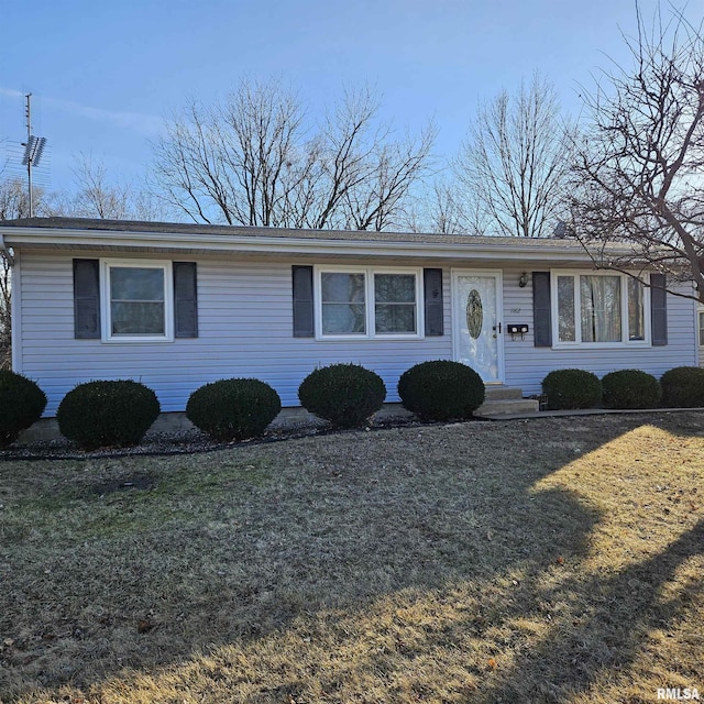 ranch-style home with a front lawn