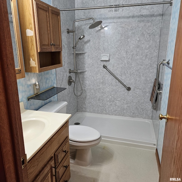 bathroom featuring vanity, toilet, and a tile shower