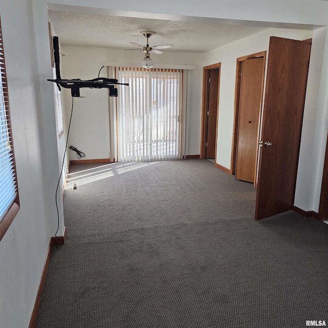 interior space featuring multiple closets, carpet flooring, and a textured ceiling