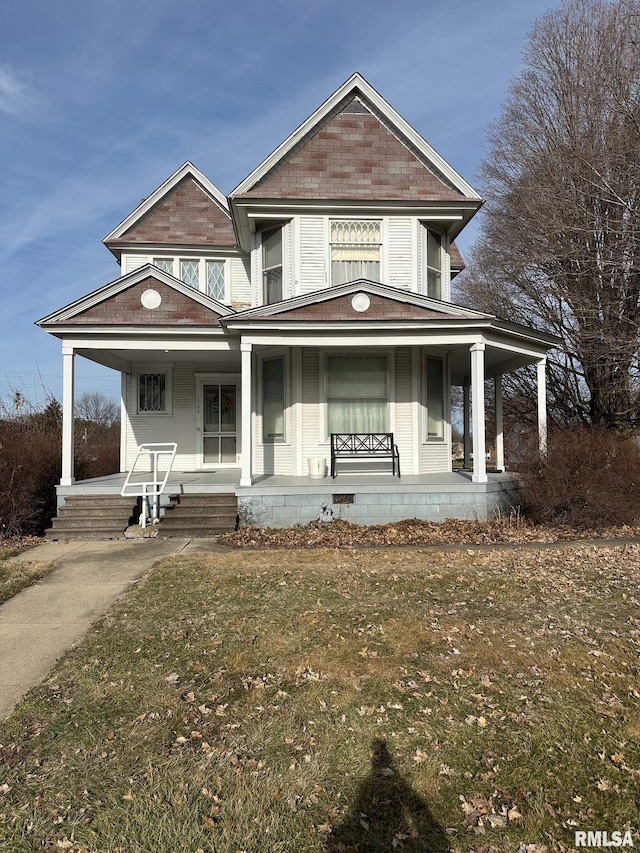 view of front of home featuring covered porch and a front lawn