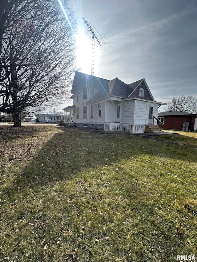 back of property featuring a lawn