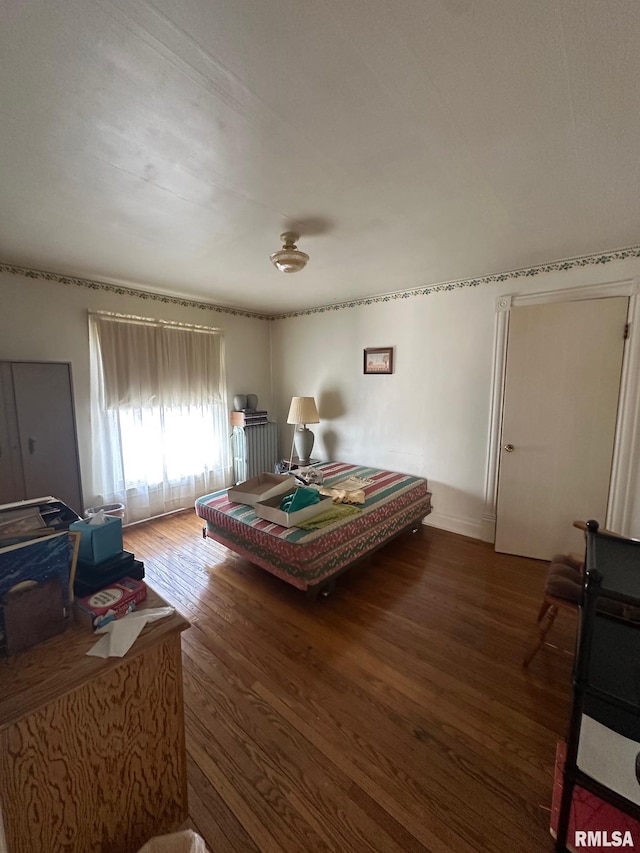 bedroom with dark wood-type flooring