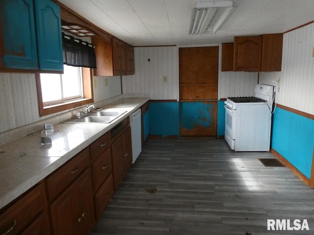 kitchen featuring white appliances, dark hardwood / wood-style floors, and sink