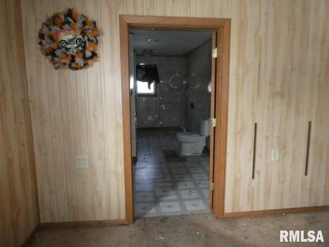 corridor featuring wooden walls