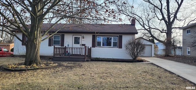 view of front of property with a garage, an outdoor structure, and a front yard