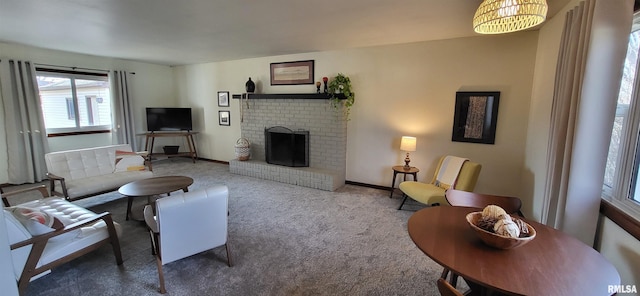 living room featuring a brick fireplace and carpet