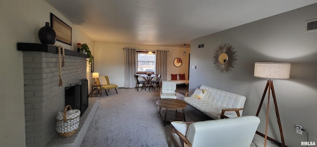 living room featuring a brick fireplace and carpet