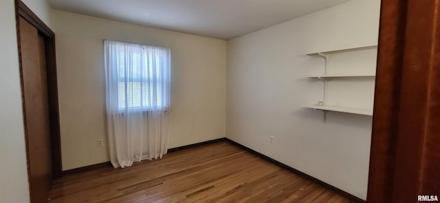 unfurnished room with hardwood / wood-style floors