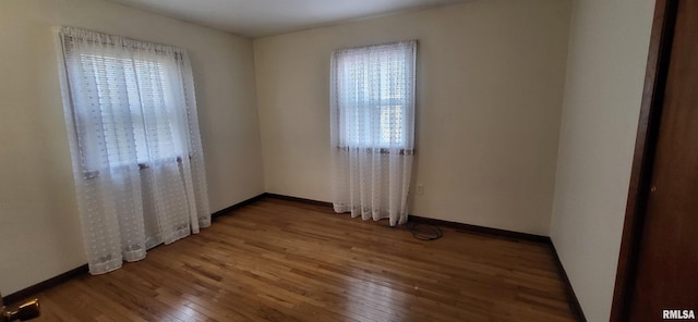 unfurnished room with hardwood / wood-style floors