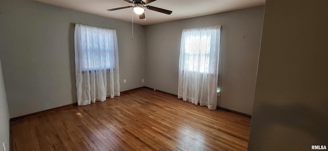 empty room with hardwood / wood-style flooring and ceiling fan