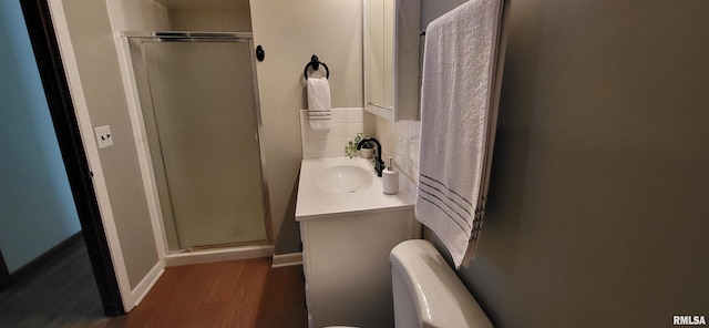 bathroom with vanity, a shower with shower door, and wood-type flooring