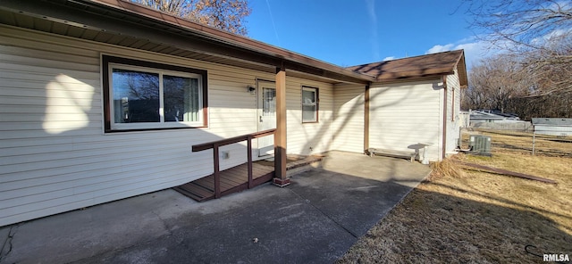 entrance to property with cooling unit and a patio area