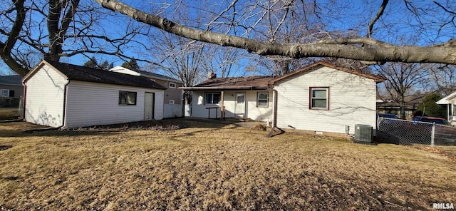 view of front of home with central AC unit and a front lawn