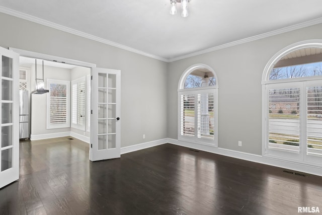 empty room with french doors, ornamental molding, and dark wood-type flooring