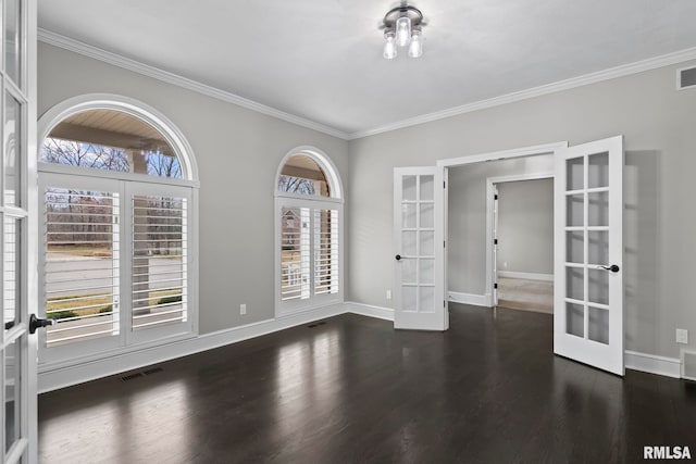 empty room with crown molding, dark hardwood / wood-style floors, and french doors