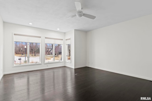 empty room with dark wood-type flooring and ceiling fan