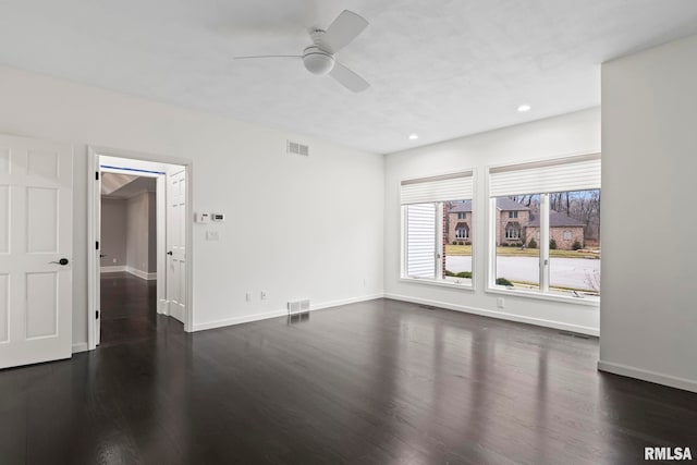 empty room featuring dark hardwood / wood-style floors and ceiling fan