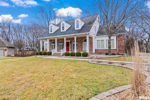 cape cod home with a front yard and a porch