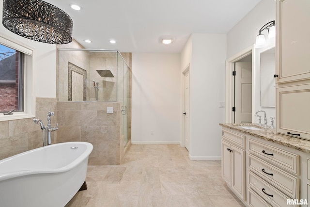 bathroom with vanity, separate shower and tub, and tile walls