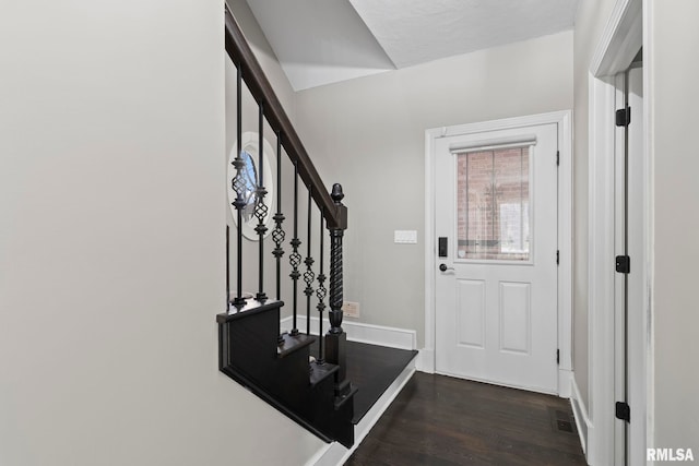 entryway with dark hardwood / wood-style flooring