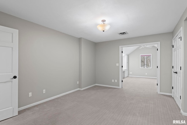 spare room with light colored carpet