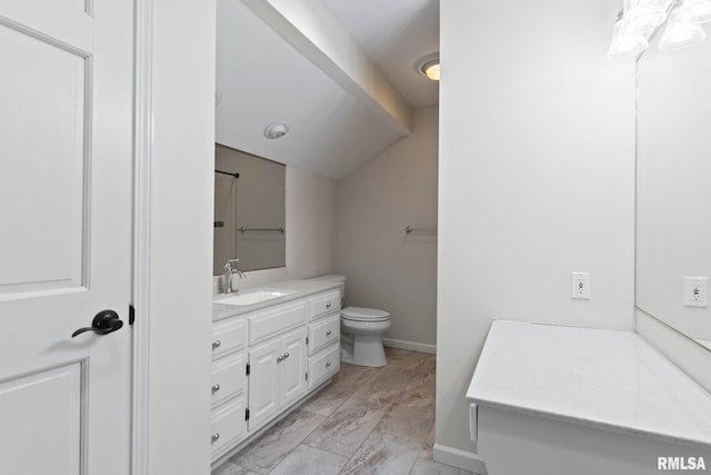 bathroom featuring vanity, toilet, and vaulted ceiling