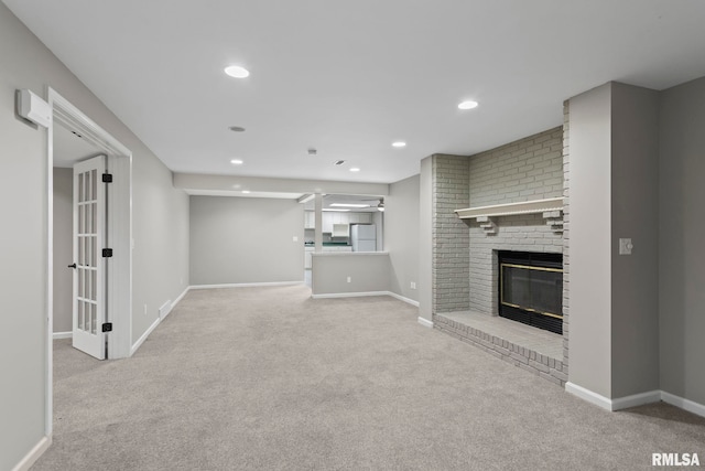 unfurnished living room featuring a fireplace and light carpet