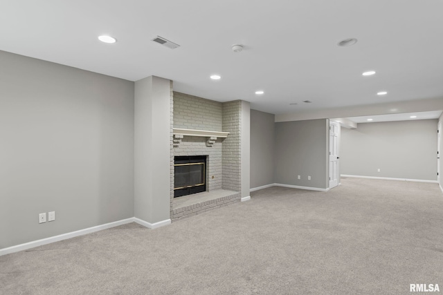 unfurnished living room featuring light carpet and a brick fireplace