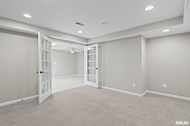 carpeted spare room with french doors and ceiling fan