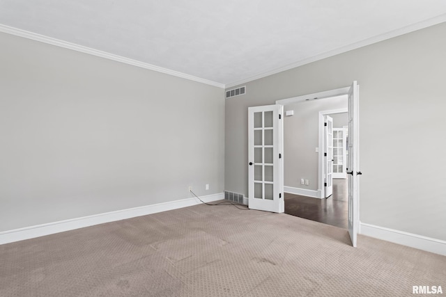 carpeted spare room featuring ornamental molding and french doors