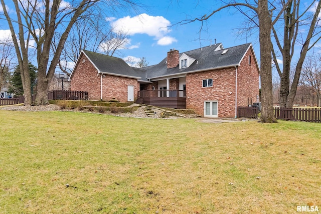 rear view of property featuring a wooden deck and a yard