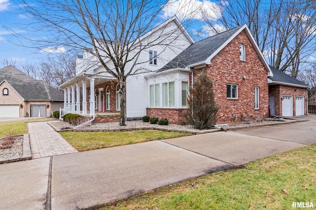 view of front of home featuring a garage, a front lawn, and a porch